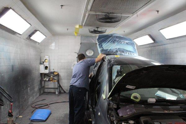 Our team working on a vehicle in our shop