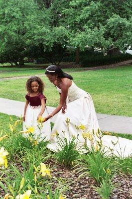 Bride and flower girl in garden