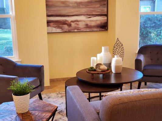 A Lovely Living room with an up close look at accessories used to create a focal point. Staged by Amethyst Interiors.