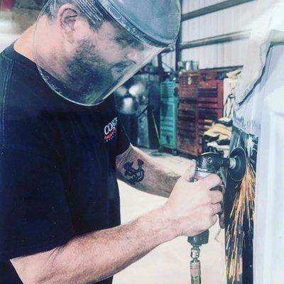 Andy Wolcott hard at working welding a corner panel