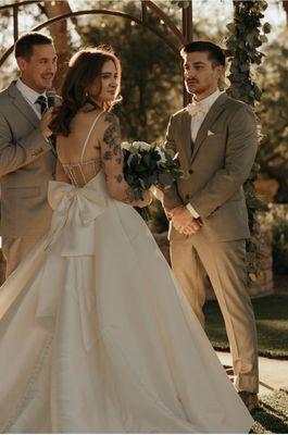 Groom in suit by celebrity tux and tails