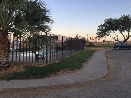 Pool with truck stop in background.