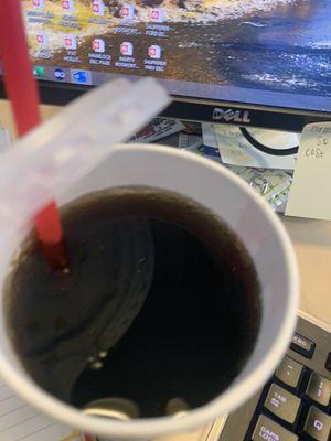 Flat warm coke without ice