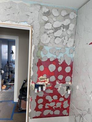 Wall after removing multiple tiles that were detached