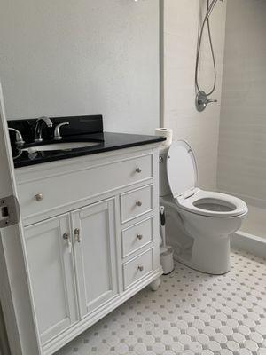 Complete bathroom remodel with new tile flooring, tile shower walls, vanity, recessed lighting beautifully installed