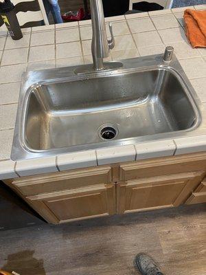 New sink installed with tile repair as well.