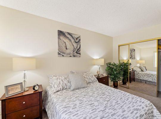 Spacious bedroom with large mirrored closet doors at the Parkview Apartment in Lake Balboa