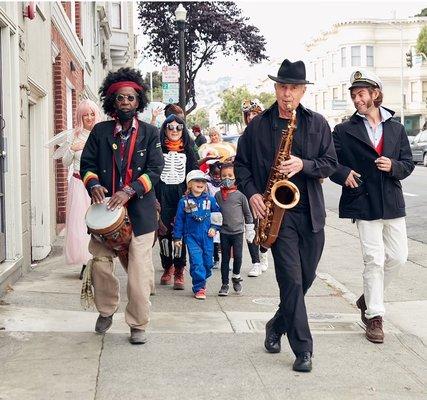 Our teachers, parents and community joining in our musical Halloween parade