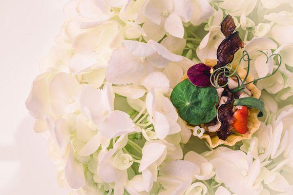 Photo taken for a private dinner. One dish of twelve, that was served on a bed of white flowers