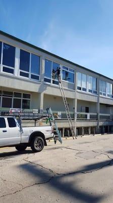 Local 2 story business Windows being serviced.