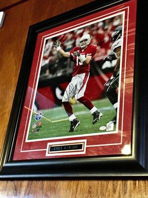 Signed Kurt Warner pic above our table.