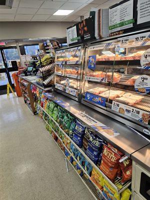 Hot food display cases on top and bags of chips on the bottom shelves.