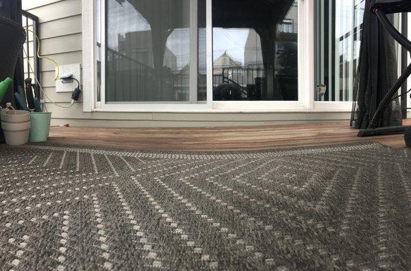 you can see how the steel deck has listed to the left, see green color under white sliding glass door increase in size, from R to L