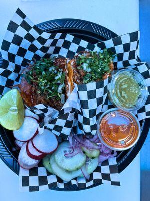 2x birria queso tacos order that includes onions, cilantro, lemon, jalapeno, pickled cucumbers, radish, green salsa and red salsa