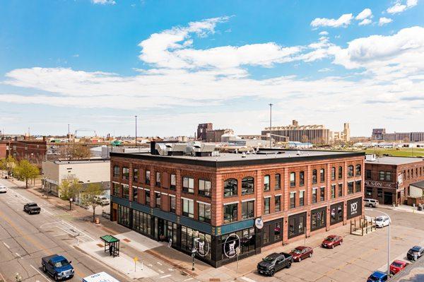 The historic Enger Lofts Hotel with the Duluth Lift Bridge in the background and Bent Paddle Brewery next door.