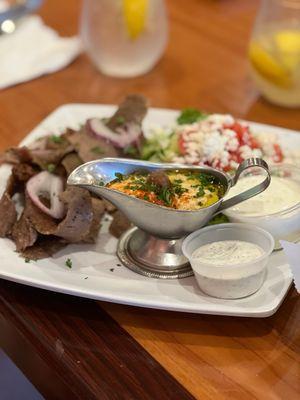 Gyro plate with hummus, garlic sauce, and tzatziki