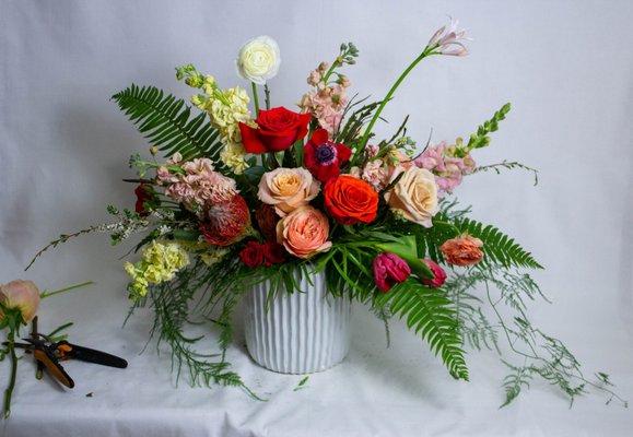 Lush arrangement in a white ceramic vase