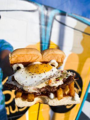 SLAW BURGER - impossible patty, fried egg, french fries, haus slaw, white american cheese, and mayo