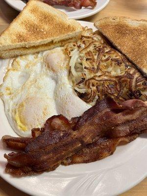 3 Eggs over medium, toast, hashbrowns, and bacon