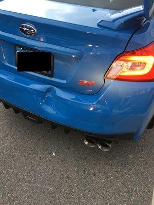 Pre-repair dent (goes into trunk)