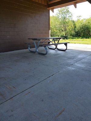 Picnic tables in the shade, made from recycled plastic