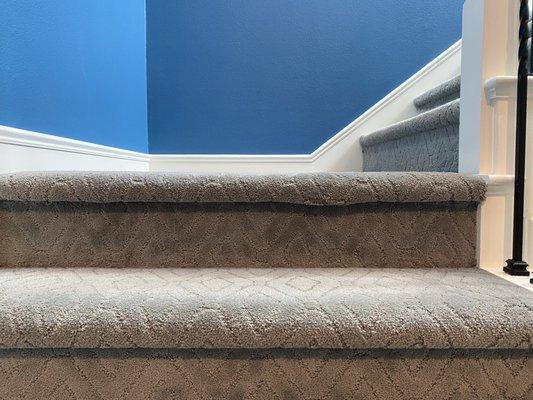 Uneven carpet on bottom step.  They told me I should trim the carpet with scissors and use a glue gun.