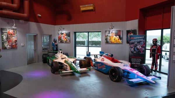 Authentic IndyCars sit on display in the lobby of K1 Speed Indianapolis