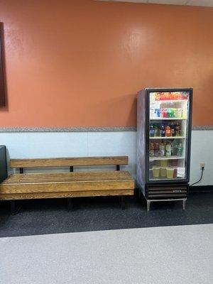 Waiting area with refrigerated drinks for purchase.