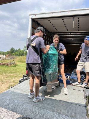 This is a picture of two employees moving a very heavy antique stove. It was very heavy, but they handled it easily.