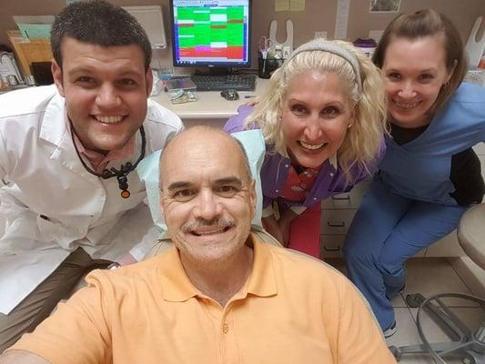 Bill Lewis working on his smile with staff from Spallone Family Dentistry.