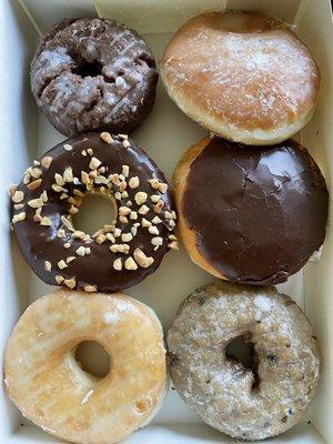 Chocolate cake, choco iced peanut, glazed, Bavarian cream, Boston cream and blueberry cake donuts.