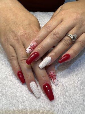 Red & white Christmas design with sweater embellishment and red snowflake detail on coffin shaped acrylic nails.