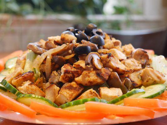 Grilled onions, mushrooms and chicken on a bed of lettuce cucumbers, and tomatoes. Topped with black olives. Sounds like the perfect salad!