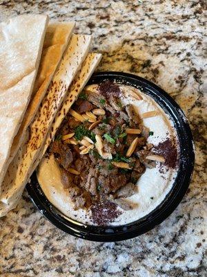 Hummus with Meat & Bread. Grilled lamb small chopped pieces, hummus, spices, olive oil and pocket bread. $5.99