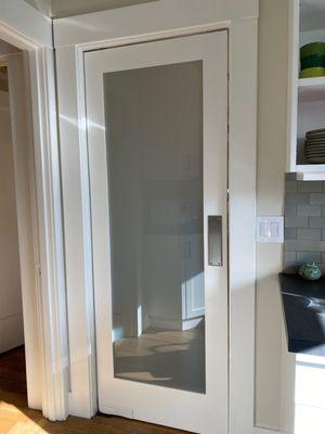 Internal swinging kitchen door with glass panel.