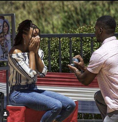 Setup for a staged marriage proposal through a caricature.