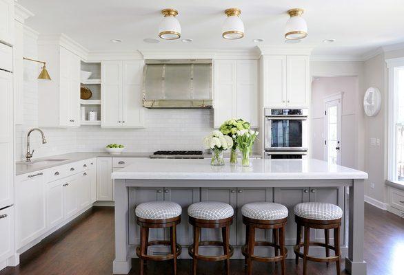 White painted kitchen cabinets with gray island