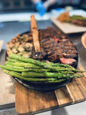 Tomahawk Steak with sautéed mushrooms and grilled asparagus