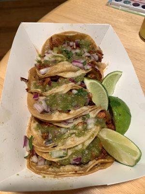 Pastor tacos with mild green sauce.