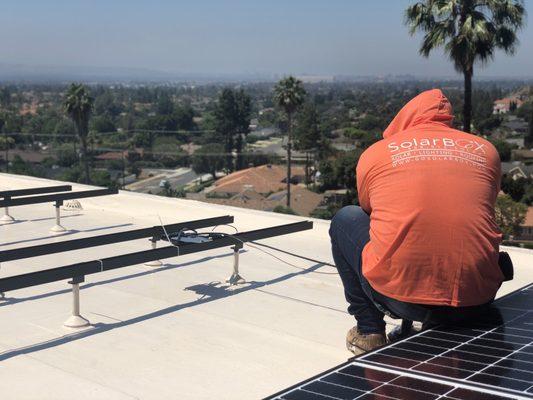 Beautiful day to install clean green power on a flat roof.