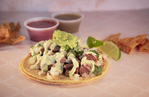 Carne asada (Steak) Taco with onions, cilantro, housemaid Creama sauce & Avocado Spread