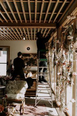 Carefully installing florals from the hotels ceiling.