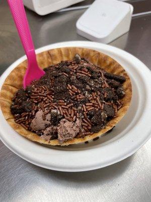 Chocolate ice cream in waffle bowl with choco toppings