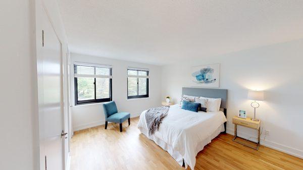 Bedroom with lots of natural light, hardwood floors and a large closet