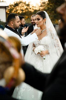 Groom making sure the Bride looks good on their big day