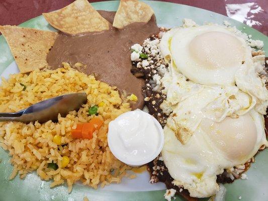 Mole chilaquiles with medium cook eggs  Chilaquiles have only queso fresco and onion