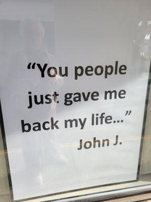 window sign says "you people just gave me back my life . . ."