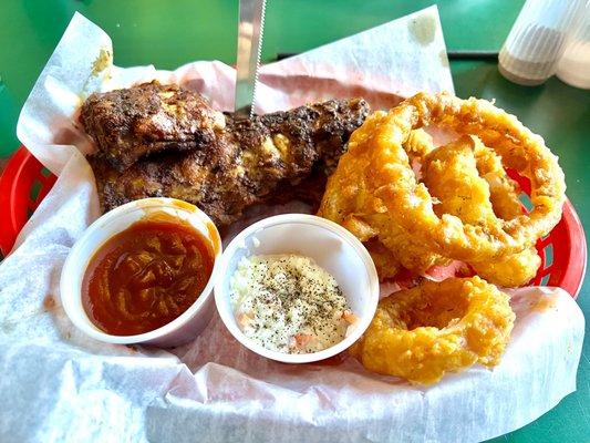 Dry rubbed baby back ribs with sauce on the side, onion rings and Cole slaw