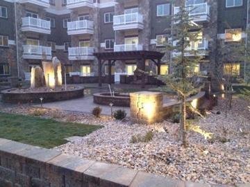 This is a courtyard we installed using Belgard pavers and walls, bubbleing rock fountain, belgard fireplace and BBQ grill, la...