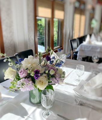 Event centerpiece by Esme featuring peonies, orchids, roses, delphiniums.